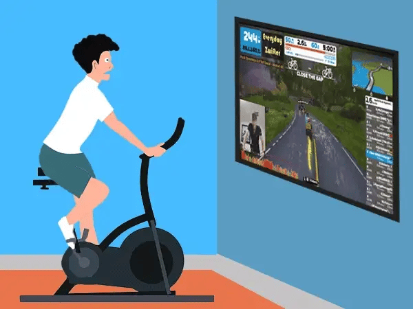 A man rides a stationary bike in front of a TV that displays a virtual bike path and his biking stats.